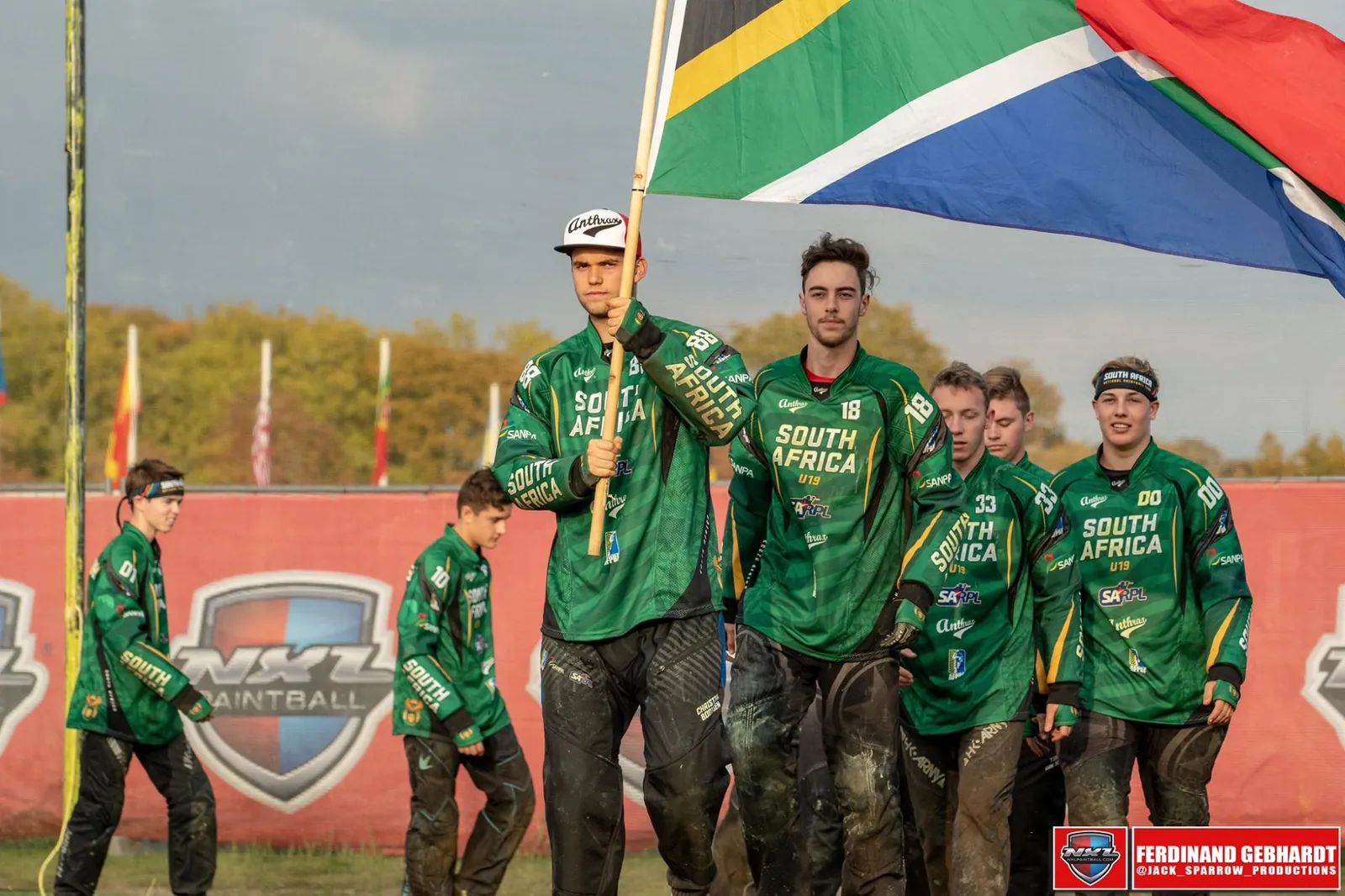 A South African player carries the national flag at the front of the U19 team at the 2018 world championship