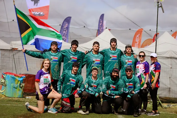 South African team and staff gathered under the flag