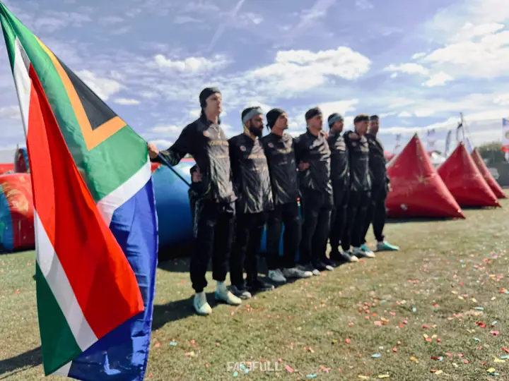 South African team standing in a line beside the flag